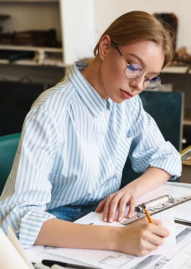 young-woman-architect-working-on-blueprints-indoor